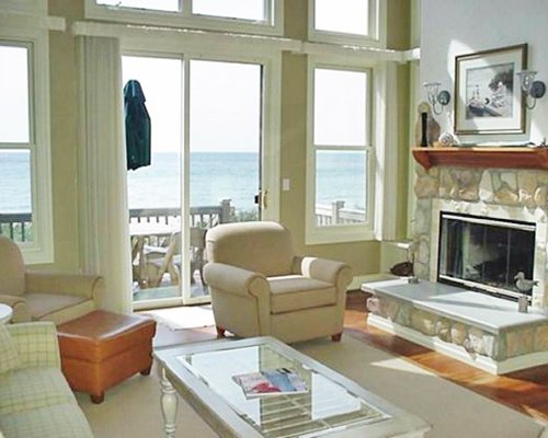 A well furnished living room with a fireplace and balcony.