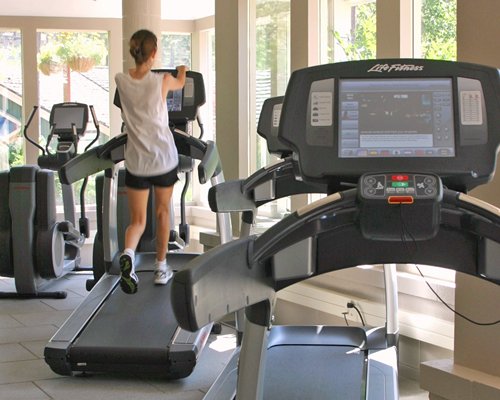 A woman exercising in an indoor fitness center.