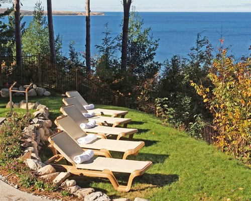 View of chaise lounge chairs alongside the beach.