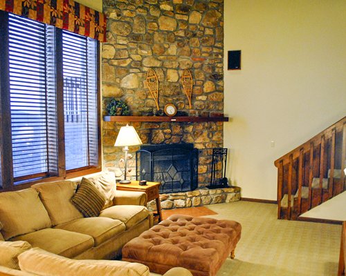 A well furnished living room with a television and fireplace.