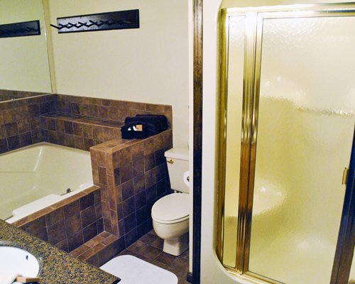 A bathroom with a bathtub and a single sink vanity.