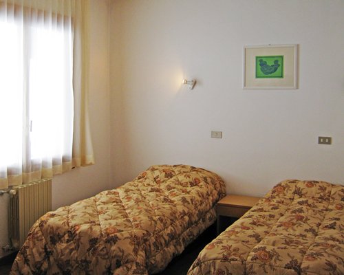 A well furnished bedroom with two beds.