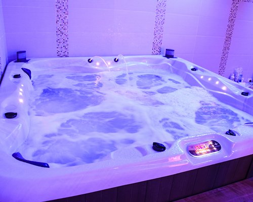 An indoor hot tub with neon lights.