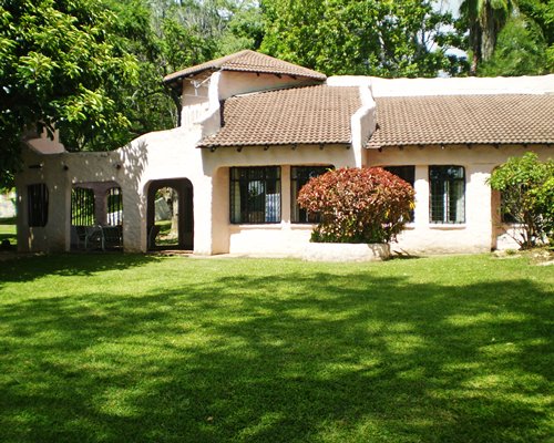 An exterior view of resort units alongside a manicured lawn.