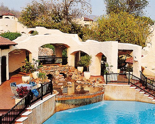 An outdoor swimming pool alongside resort units.