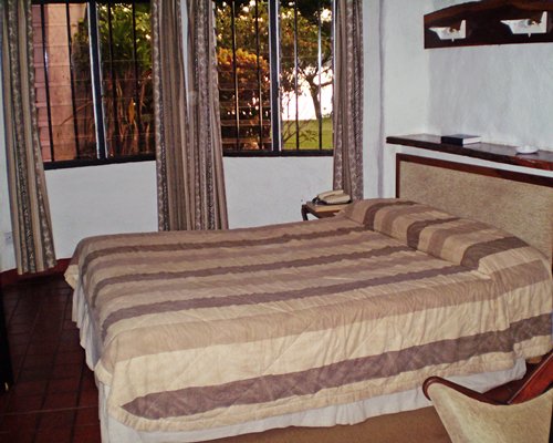 A well furnished bedroom with a double bed and outside view.