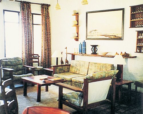 A well furnished living room with sofas and an outside view.