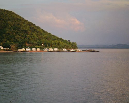 A lake alongside the resort in the foothills of a mountain.