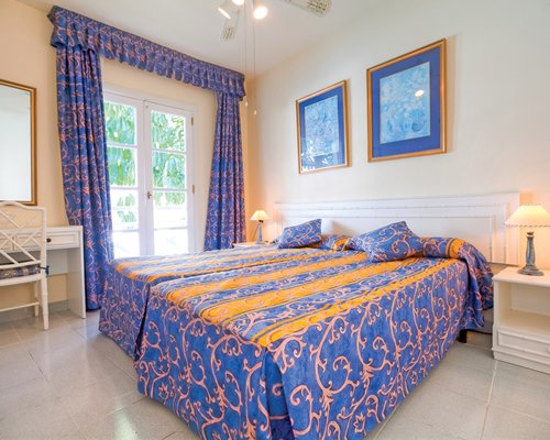 A well furnished bedroom with an outside view.