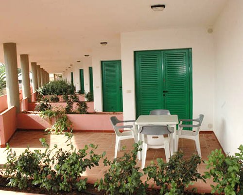 An outdoor patio at Hotel Villaggio Cala Corvino.