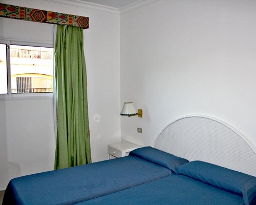 A well furnished bedroom with an outside view.