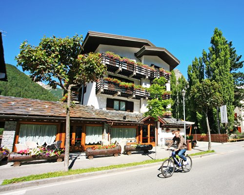 A man cycling on a road alongside the resort.