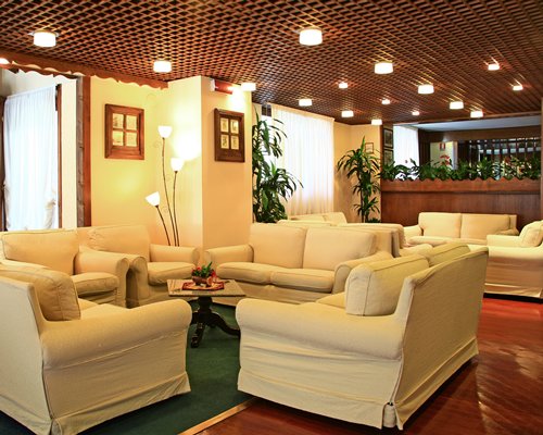 An indoor lounge area of the Domina Home Les Jumeaux resort.