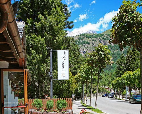 Street view of the resort units with parking lot surrounded by trees.