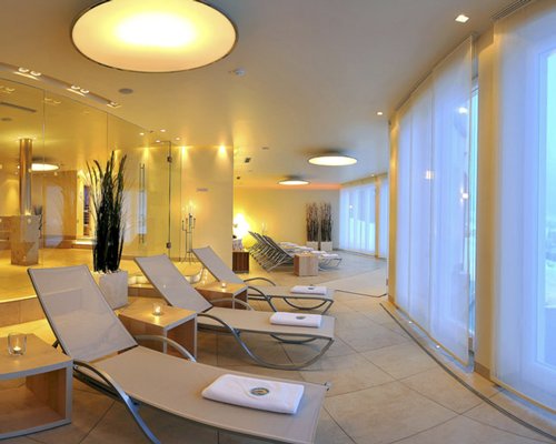 View of chaise lounge chairs in a well furnished indoor area.