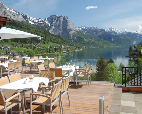 An outdoor fine dining area with a lake view.