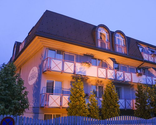 An exterior view of multi story resort units at dusk.