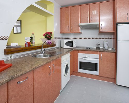 A well equipped kitchen with a microwave and refrigerator.