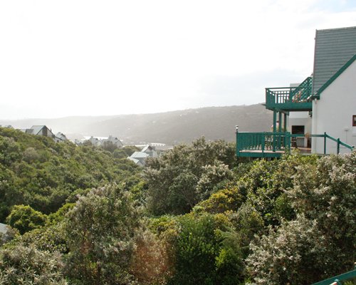A balcony view of the Wilderness Dunes resort surrounded by woods.