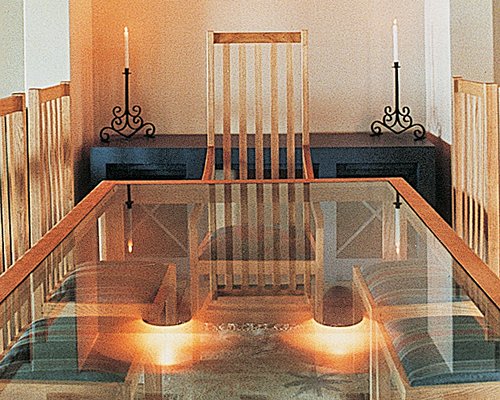 A dining room with a glass top table.
