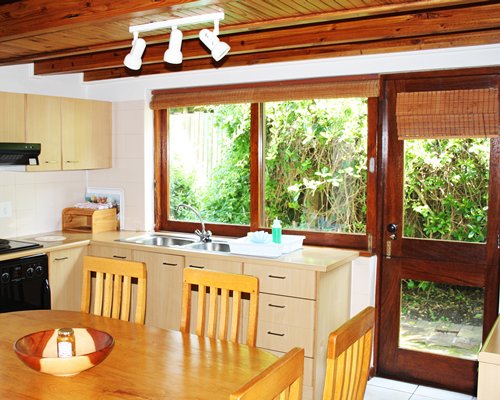 An open plan dining and kitchen area with an outside view.
