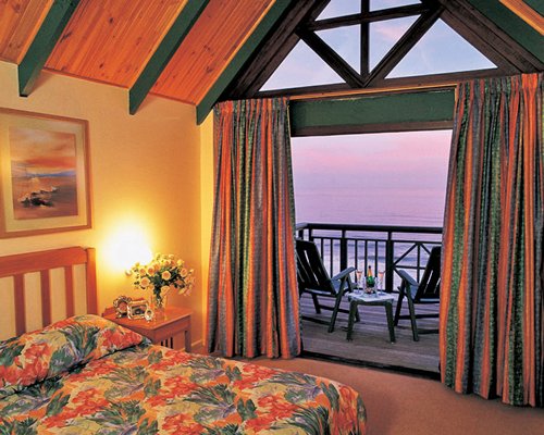 A well furnished bedroom with a balcony.