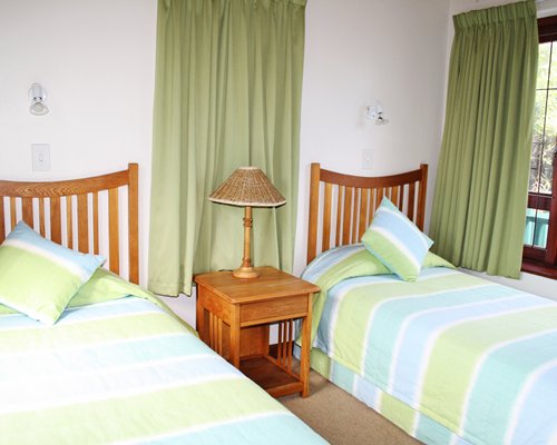 A well furnished bedroom with two twin beds.