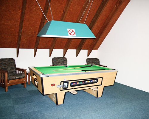 An indoor recreation room with pool table.
