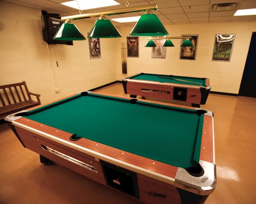 An indoor recreational room with pool tables.