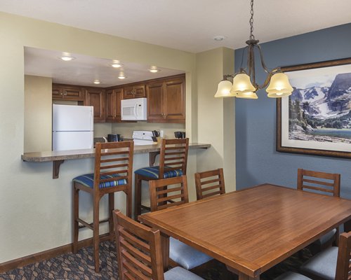 A well equipped kitchen and dining area with a breakfast bar.