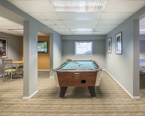 Indoor recreation room with pool table.
