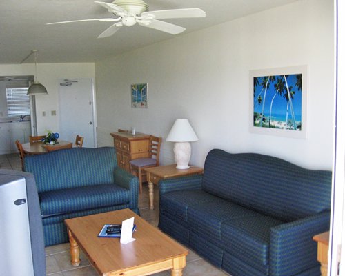 A well furnished living room with a dining area and kitchen.