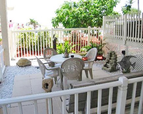 A patio accompanied by furniture with outside view.