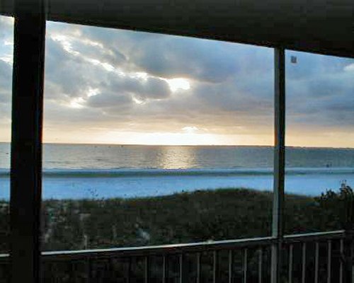 A balcony view of a beach at dusk.