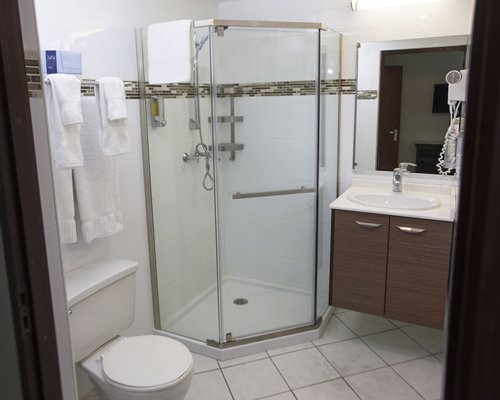 A bathroom with shower stall and closed sink vanity.