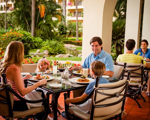 A family dining at an indoor dining of Club Velas Vallarta resort.