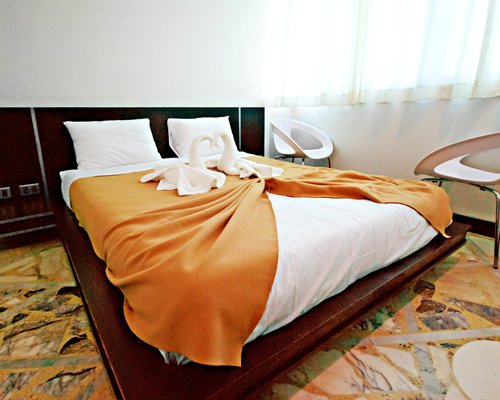 A well furnished bedroom with king bed.