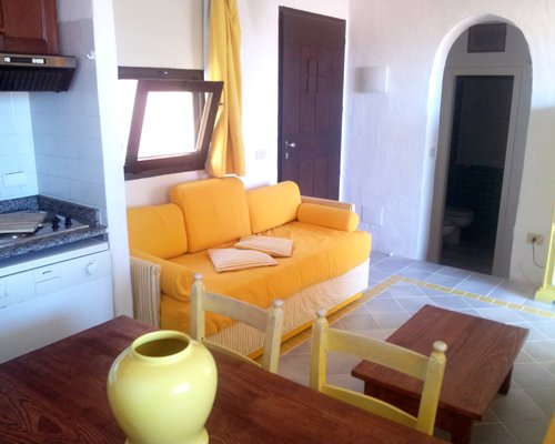 A well furnished living room with a dining area and open plan kitchen.