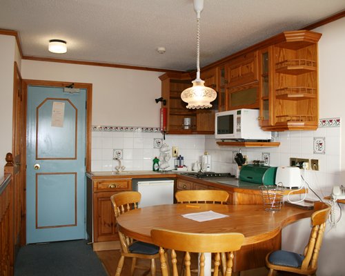 A well equipped kitchen with dining table.