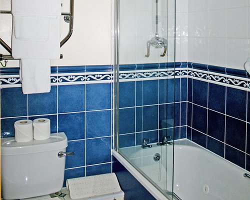 A bathroom with a shower and bathtub.
