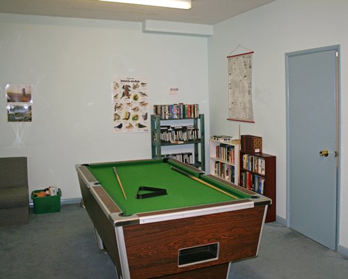 An indoor recreational room with a pool table.