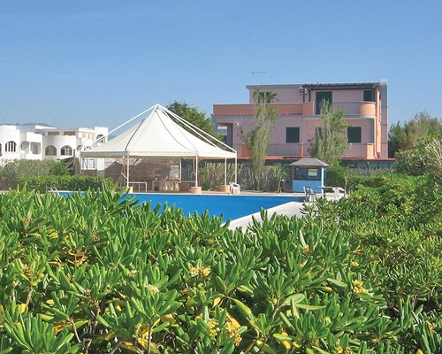 A scenic outdoor swimming pool alongside the resort.