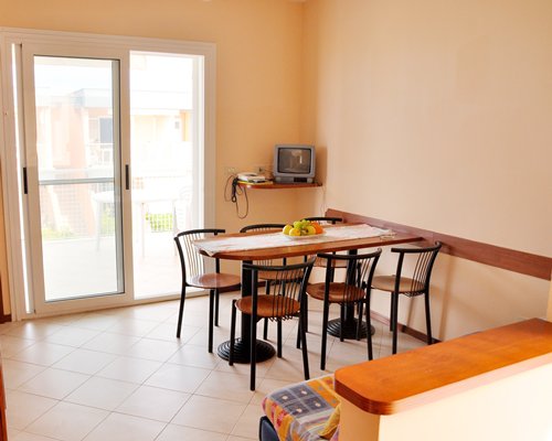 A well furnished dining room with a breakfast bar and patio.