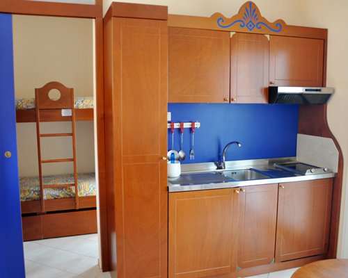 An open plan kitchen with two bunker beds.