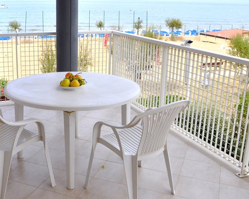 A balcony with patio furniture and an outside view.