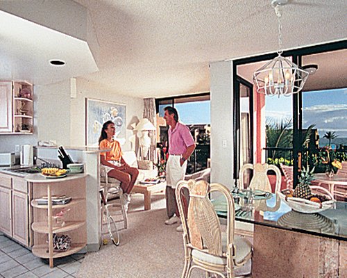 An open plan living dining and kitchen area with a balcony.