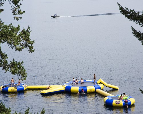 View of people in an inflatable water blob jump balloon in a lake.