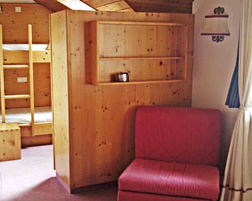 Furnished living room with a pull out sofa and view of bedroom with bunker beds.