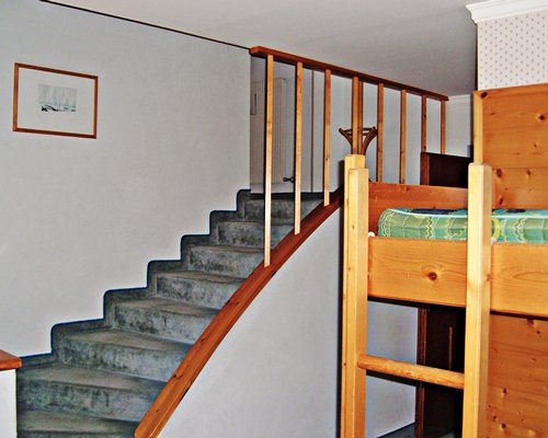 A stairway and bunker bed.