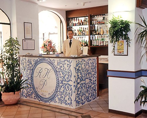 A bar counter and reception at Domina Home Royal.